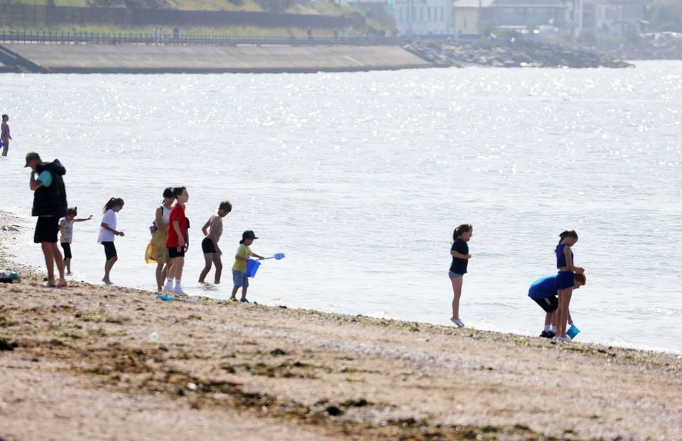 People enjoy a walk in Sea Park, Holywood during the warm weather on Tuesday. Press Eye - Belfast