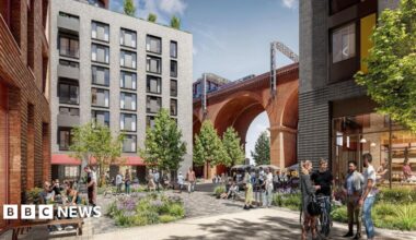 A CGI image of the planned development in Stockport. The historic viaduct can be seen in the background of the image with a seven-storey building to the left-hand side. There are trees and shrubbery planted in the square in front of the building