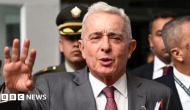 Colombian former President Álvaro Uribe gestures as he speaks to the press outside a court complex at the end of his trial in Bogota on February 10, 2025.