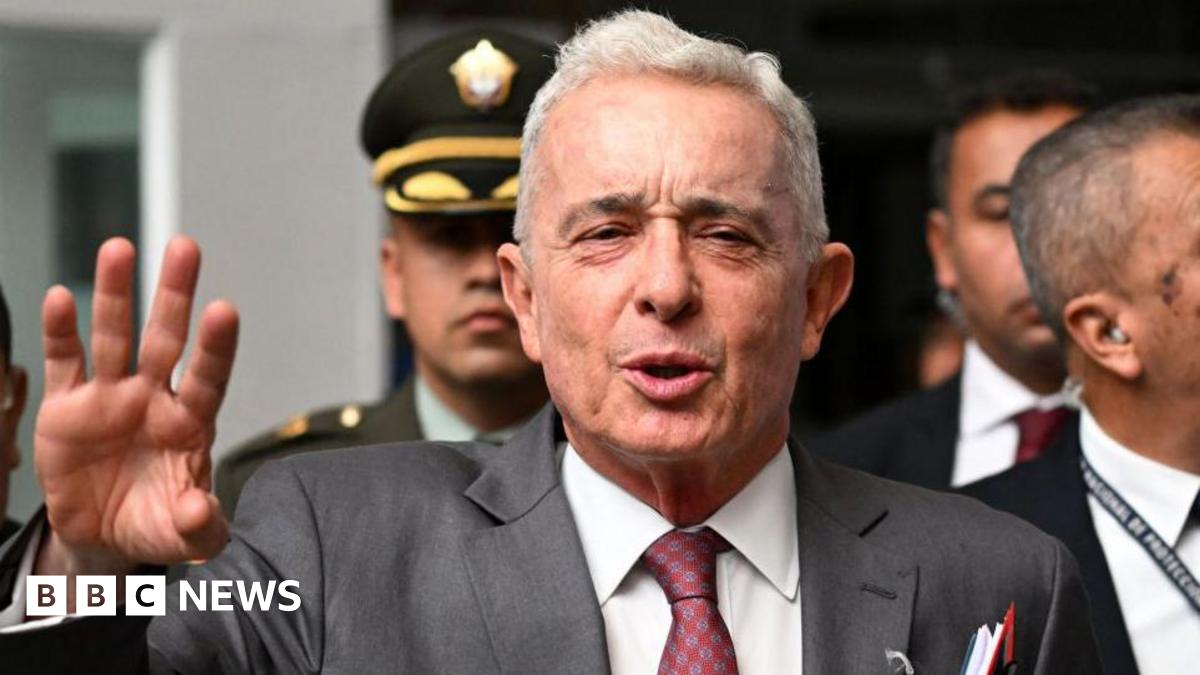 Colombian former President Álvaro Uribe gestures as he speaks to the press outside a court complex at the end of his trial in Bogota on February 10, 2025.