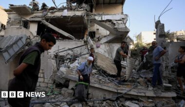 Palestinians inspect the site of an overnight Israeli strike on a house, in Gaza City.