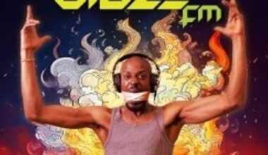 DJ from the show stands with arms up in the air, the words Blaze FM at the top, surrounded by fire.
