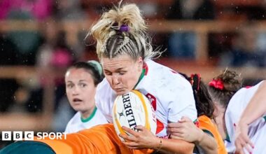 Alex Callender is tackled whilst holding the ball