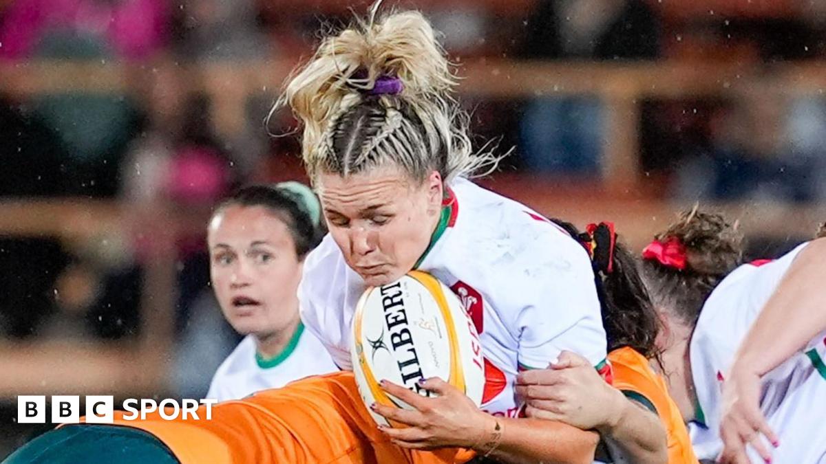 Alex Callender is tackled whilst holding the ball