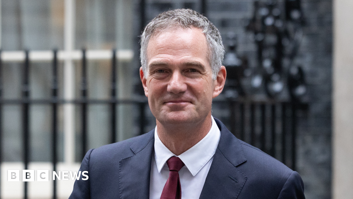 Peter Kyle. He has short smart grey hair and is wearing a sharp blue suit with a white shirt and red tie. He appears to be leaving 10 Downing Street.