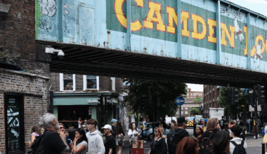 People walking near the famous sign for Camden Lock in north London