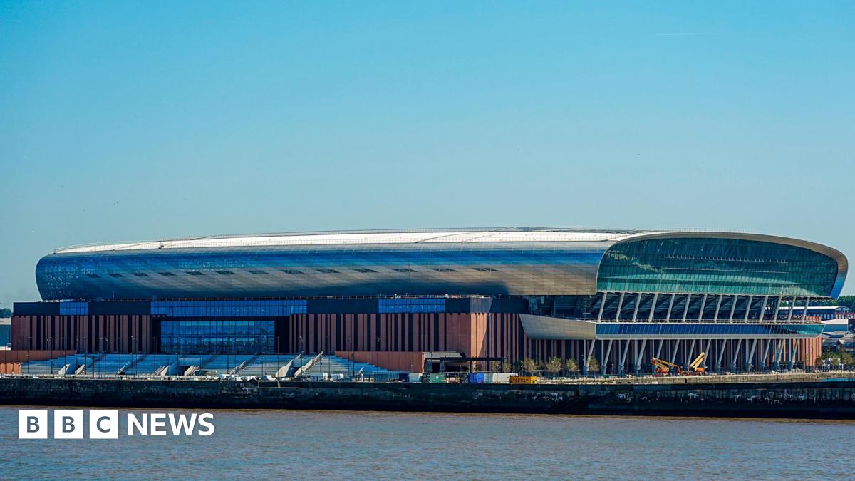 Image shows the Hill Dickinson Stadium, home to Everton FC. It is an oval-shaped stadium that sits on the Liverpool waterfront to the north of the city.