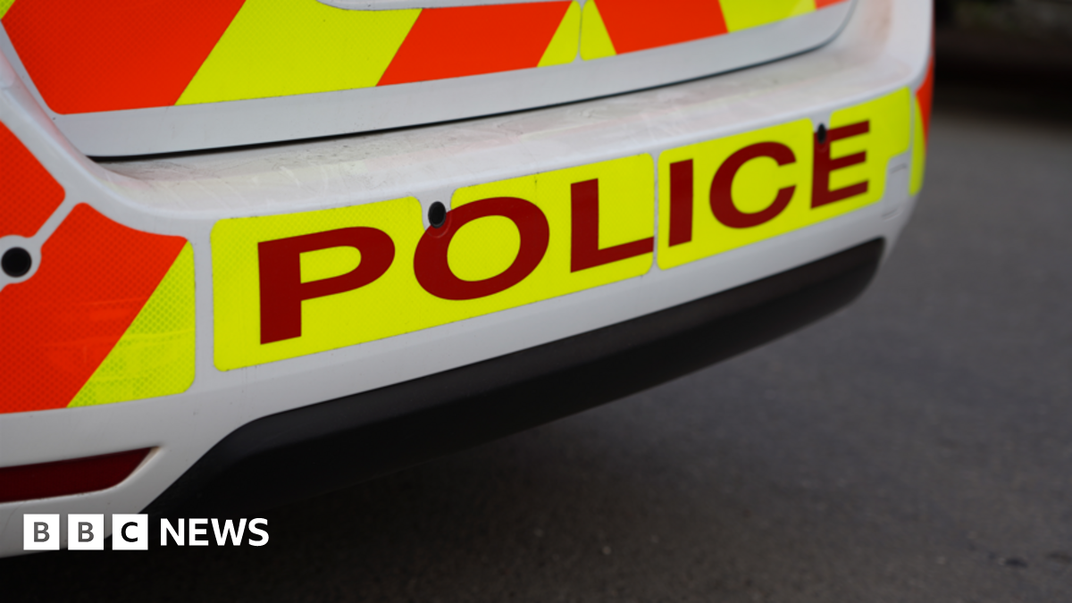 A high visibility police car with police written on the back of it