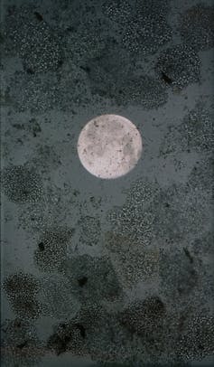 A piece of art showing a huge silvery full moon on a black textured background.