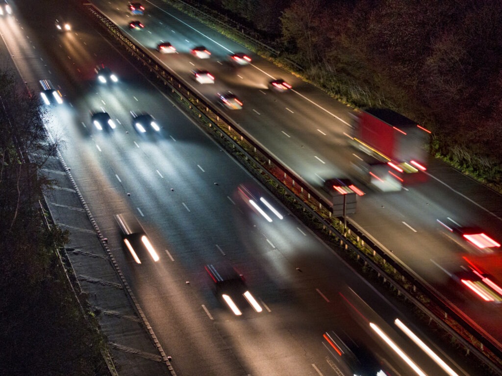 Cars on a road in France at night