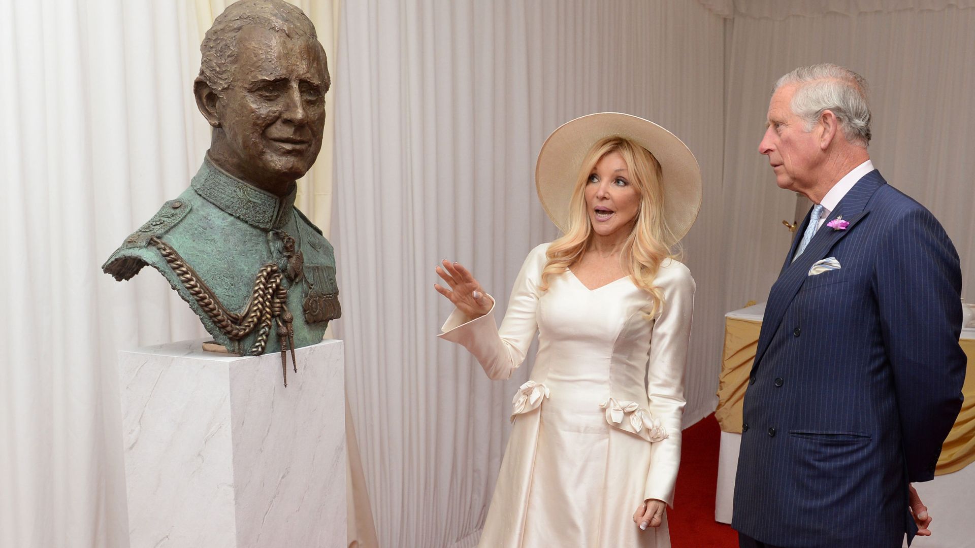 King Charles is shown a sculpture of himself, by the artist Frances Segelman, during a garden party to mark the 40th anniversary of The Prince's Trust charity in 2016