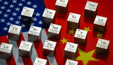Metal cubes representing rare earth elements including Neodymium (Nd), Praseodymium (Pr), Dysprosium (Dy), Terbium (Tb) and others are displayed with their symbols and atomic numbers on overlapping flags of the United States and China.