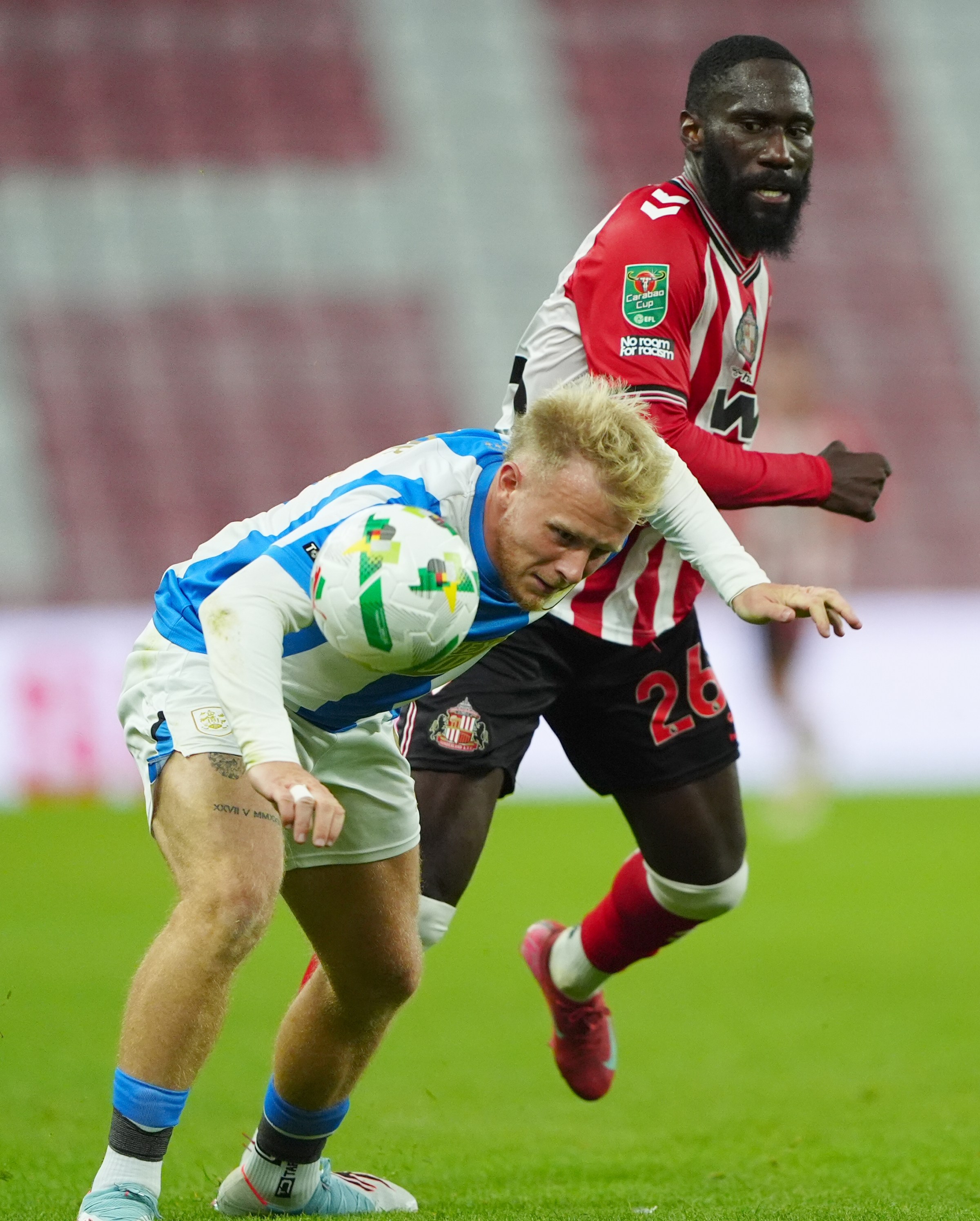 Sunderland’s Arthur Masuaku and Huddersfield Town’s Joseph Taylor battle for the ball during the Carabao Cup second round match at Stadium of Light , Sunderland. Picture date: Tuesday August 26, 2025. (Photo by Owen Humphreys/PA Images via Getty Images)