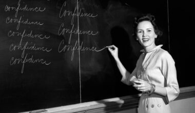 A female teacher uses a blackboard in a classroom