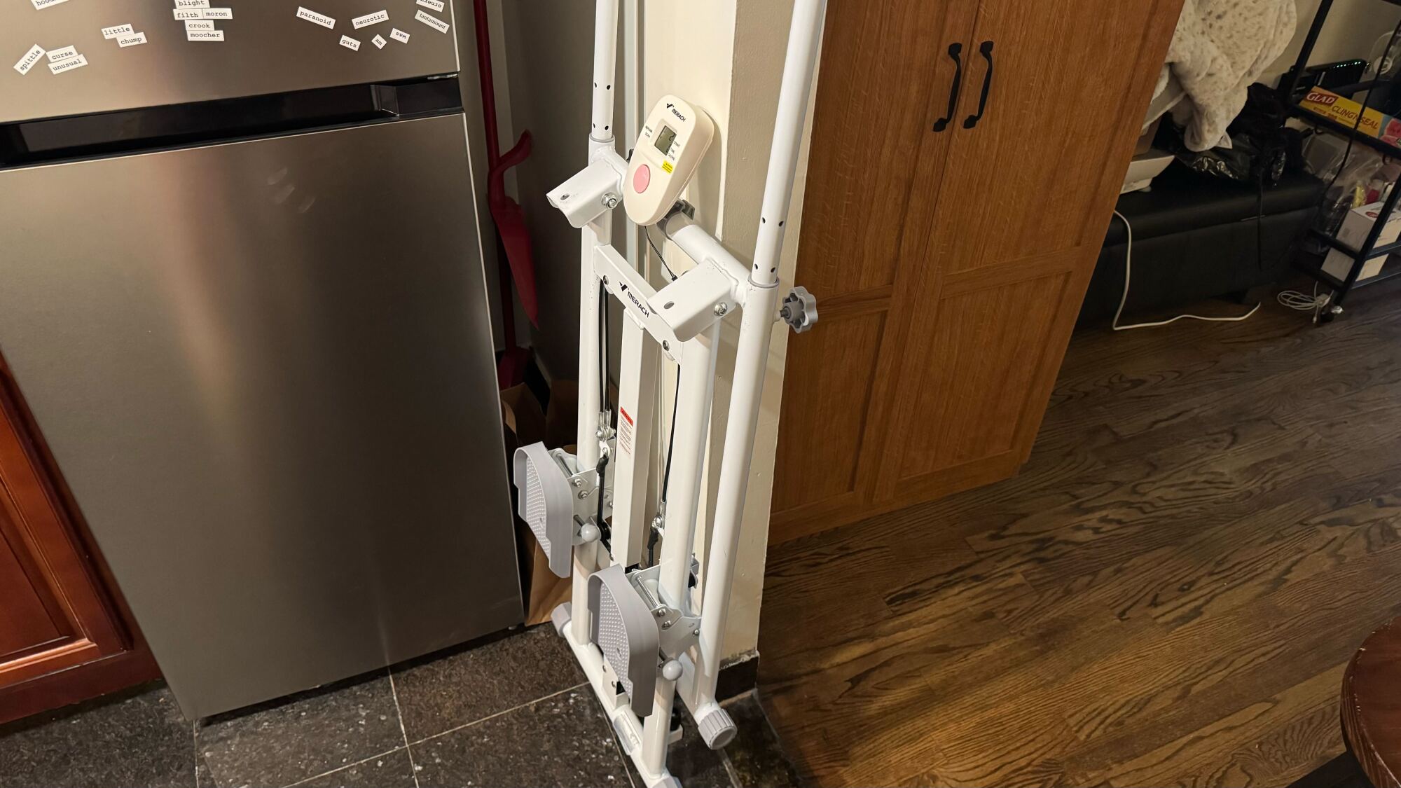Merach stair stepper by fridge