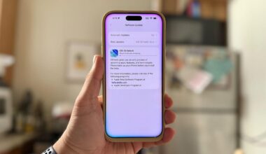 an iPhone with iOS 26 downloading on it