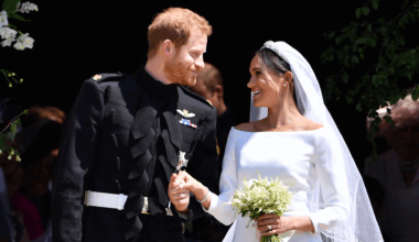 Prince Harry and Meghan Markle on their wedding day smiling at each other