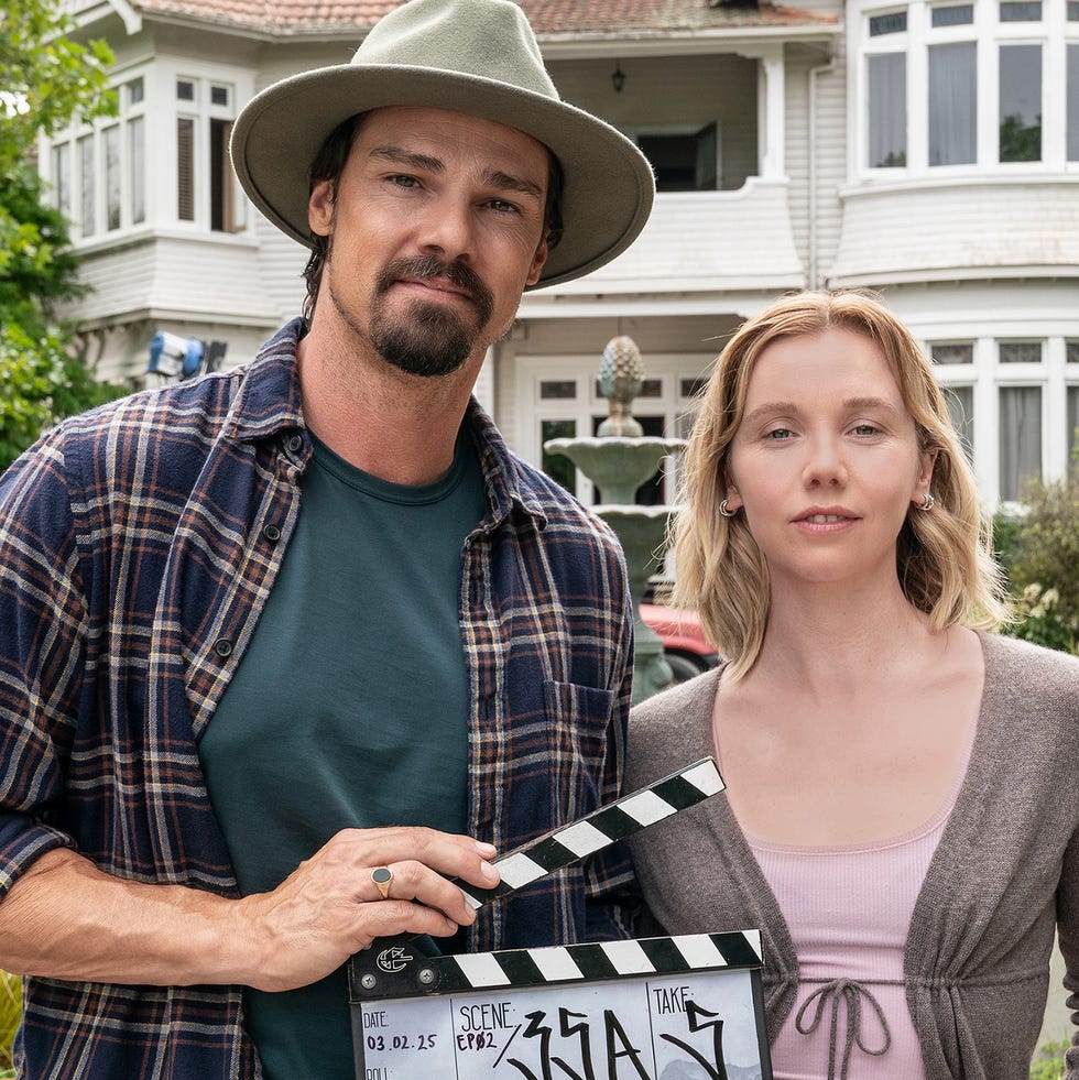 jay ryan, lauren lyle holding a clapperboard while on set for the ridge