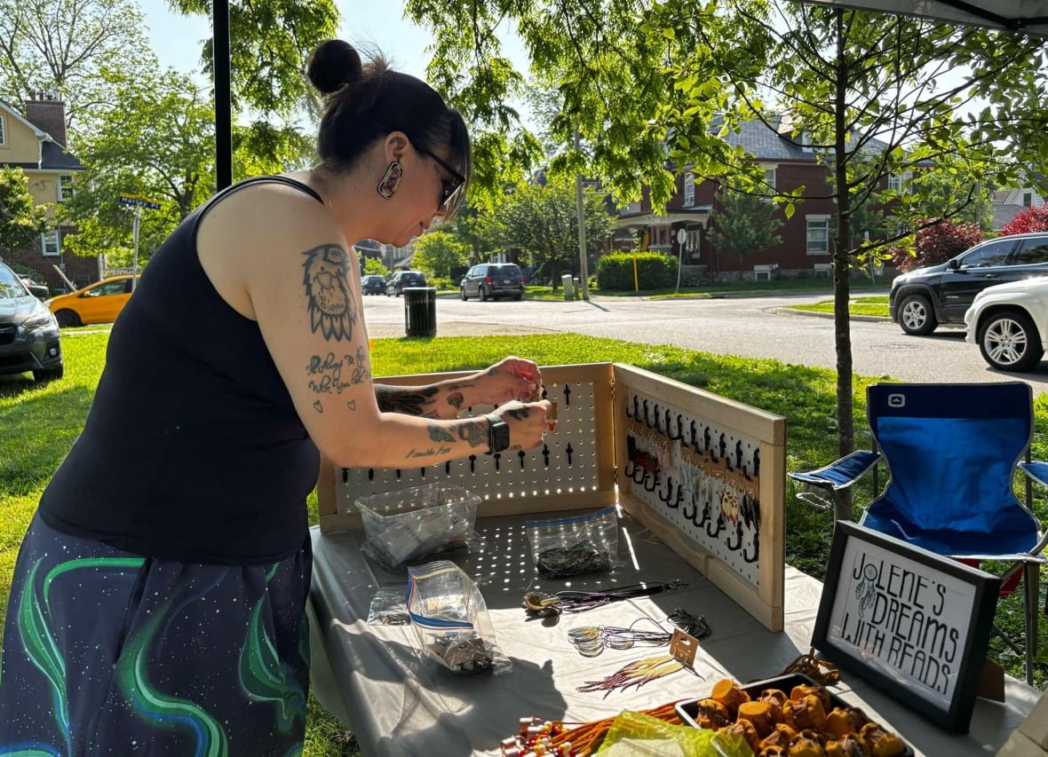 A woman puts earrings on a table