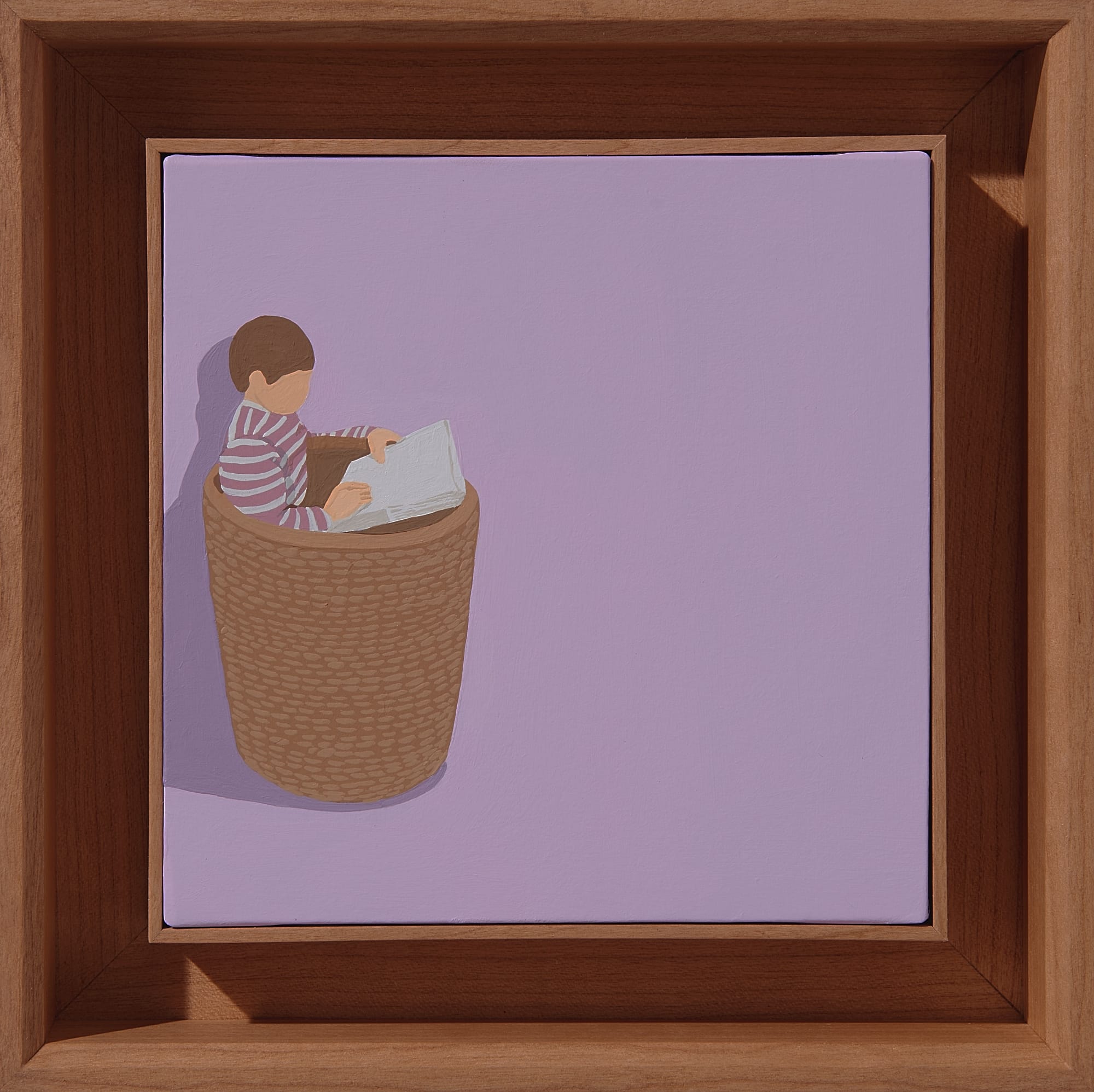 a framed square painting with a purple background and a small child reading in a brown basket