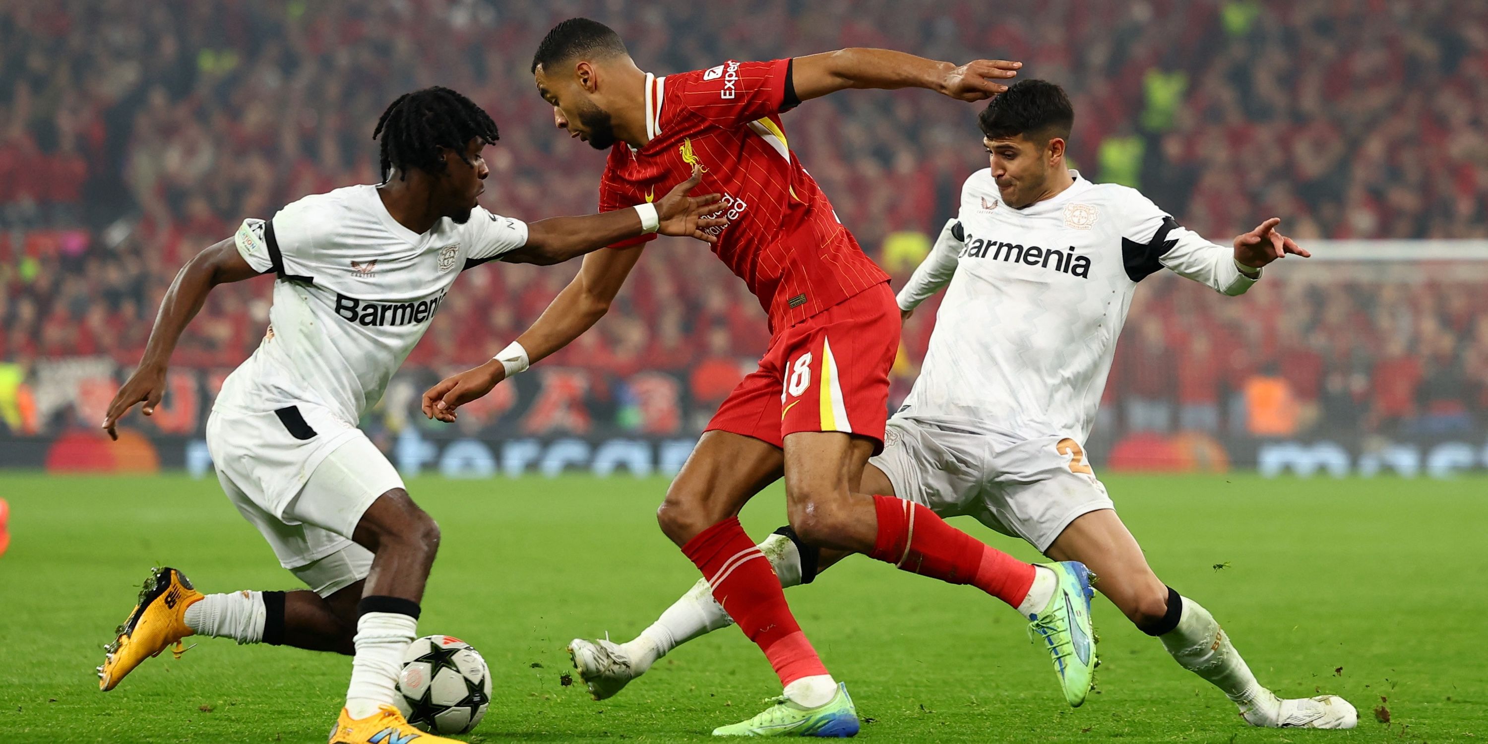 Liverpool's Cody Gakpo in action with Bayer Leverkusen's Jeremie Frimpong and Bayer Leverkusen's Exequiel Palacios