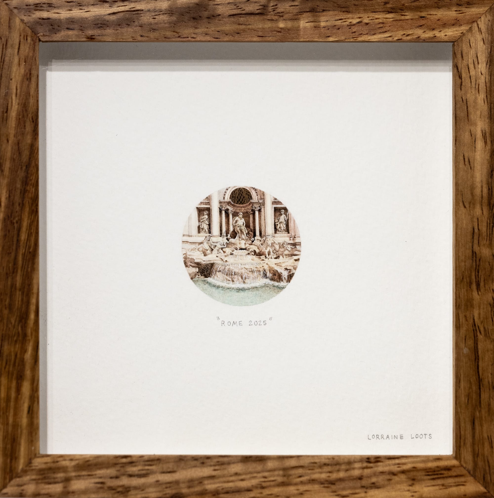 a tiny framed painting of the Trevi Fountain