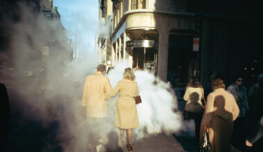 A photo of people walking in Manhattan, wearing camel trench coats, by Joel Meyerowitz