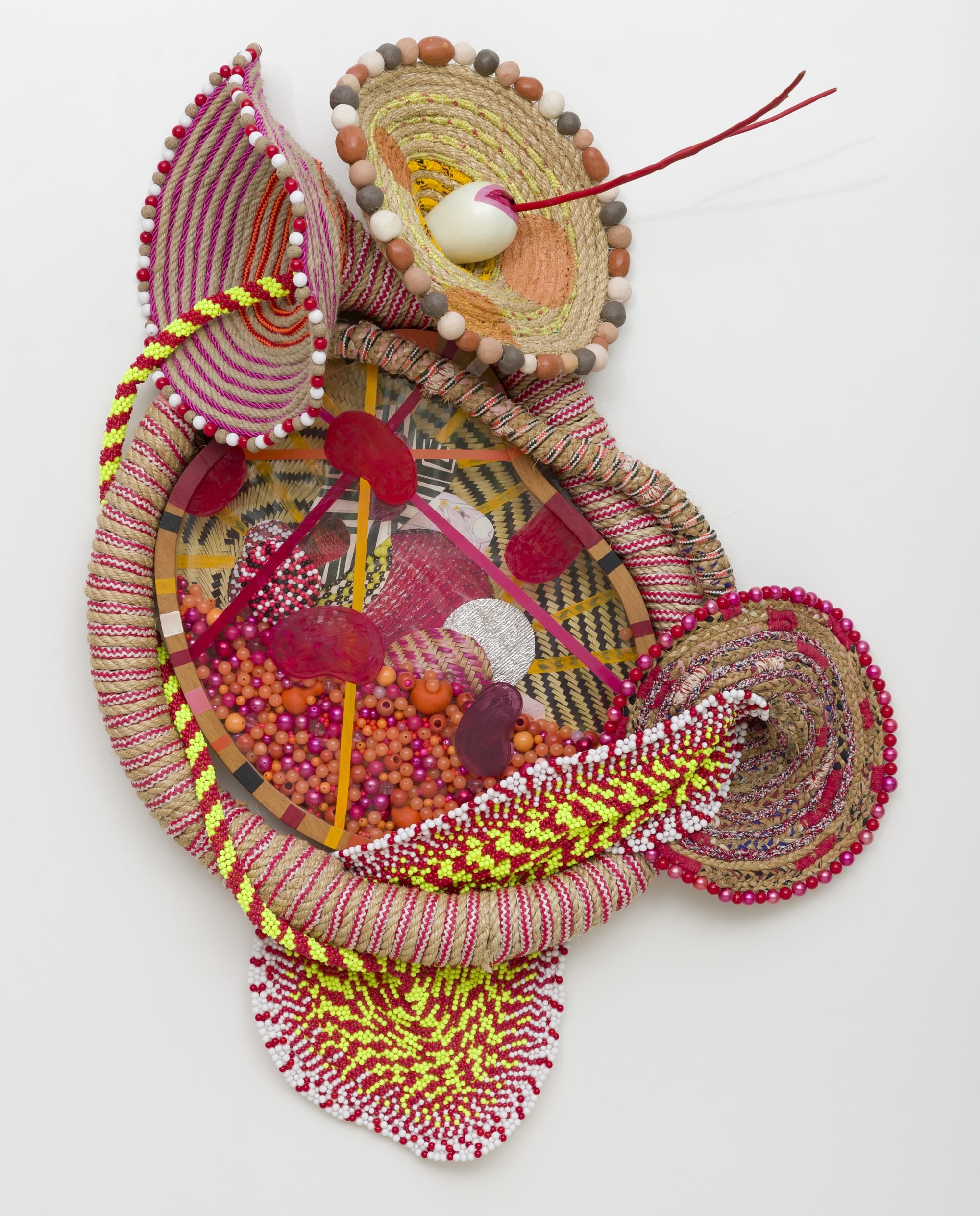 an abstract wall sculpture by Maria Nepomuceno made of beads, resin, wood, and string