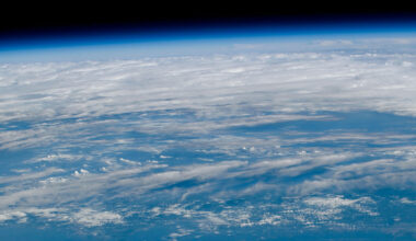 a view of Earth as seen from orbit with blue waters and white clouds set against the blackness of space