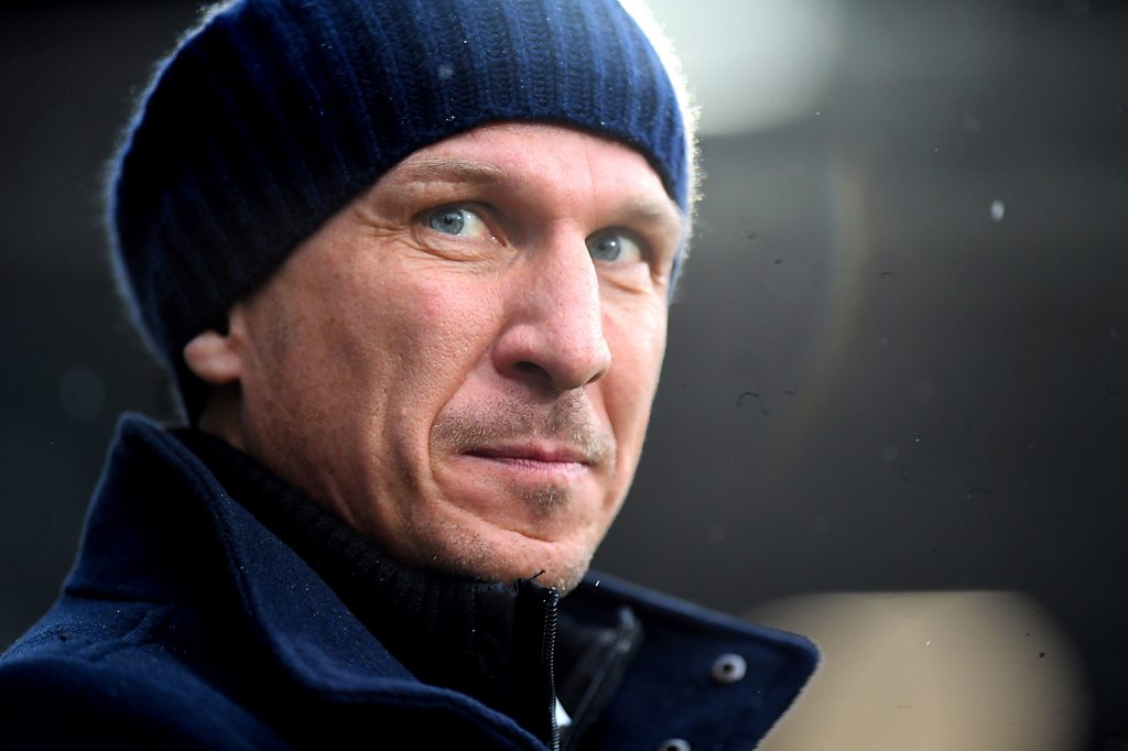 Gerhard Struber wearing a dark beaning and dark jacket with light blue eyes looking at the camera