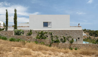 pieris architects embeds layered stone residence into greek hillside