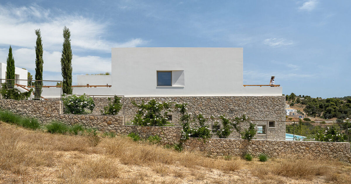 pieris architects embeds layered stone residence into greek hillside