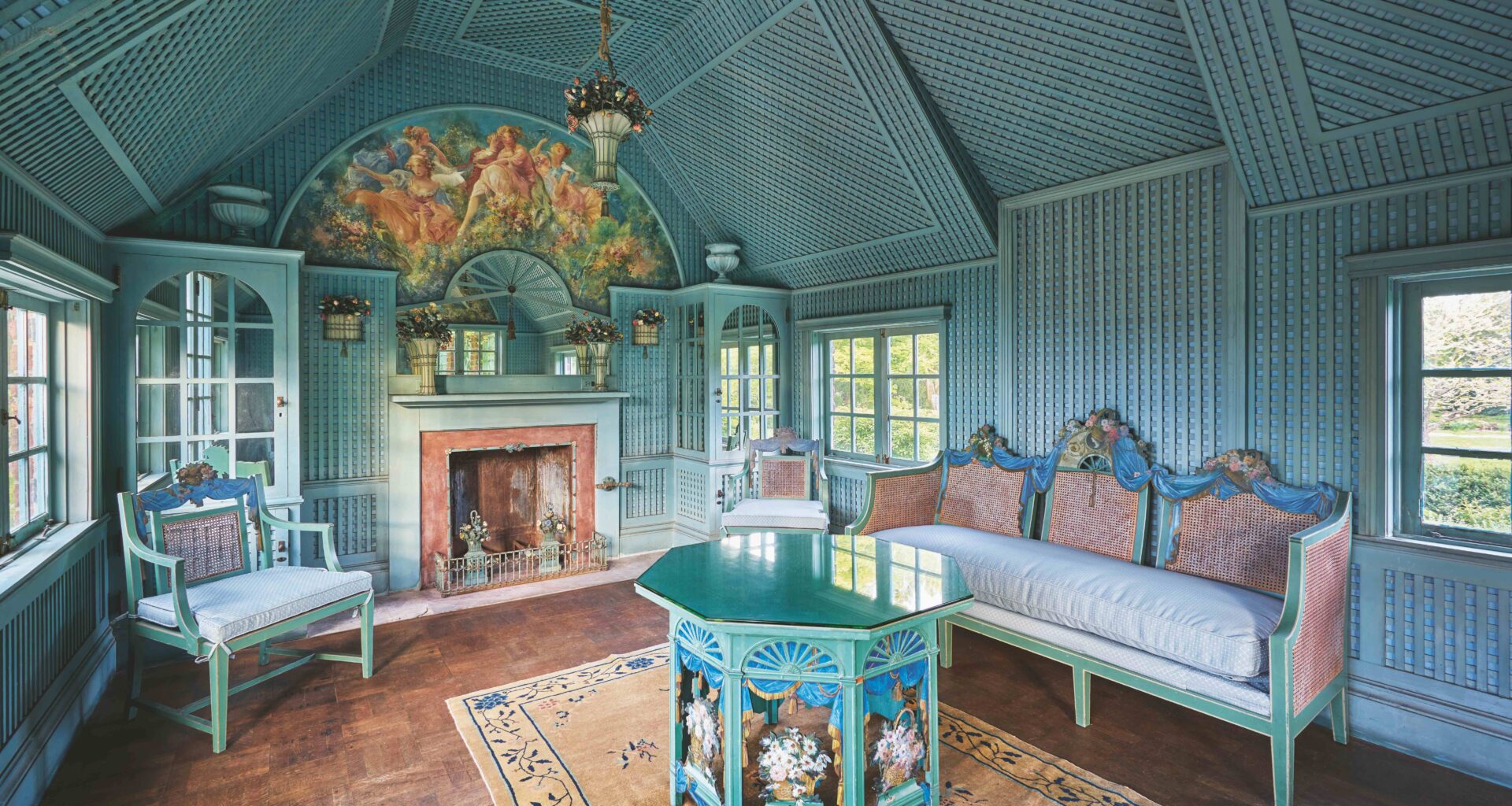 blue-panelled room with blue-green baroque furnishings and wooden parquet floor