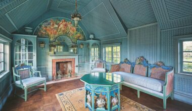 blue-panelled room with blue-green baroque furnishings and wooden parquet floor