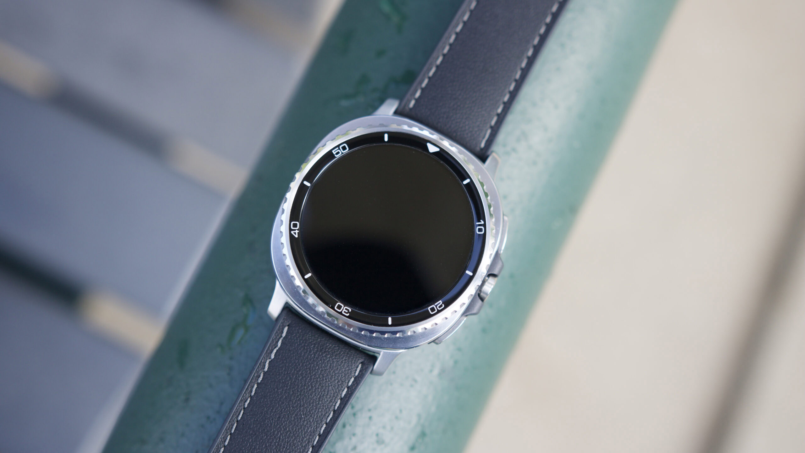 Samsung Galaxy Watch 8 Classic laying flat with its screen off.