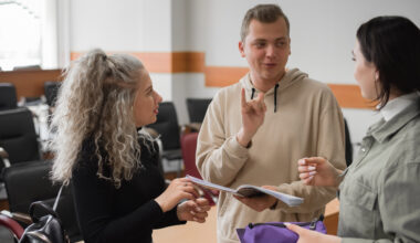Image of three young people signing to each other