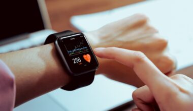 A person tapping the screen of a smartwatch.