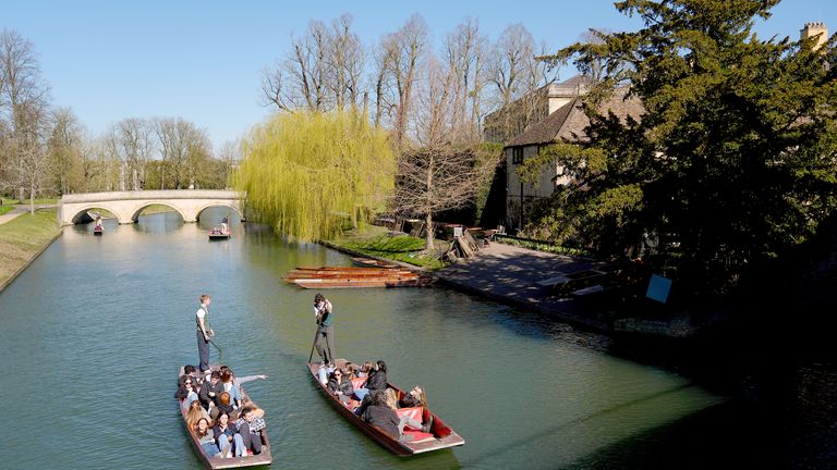 People enjoy the sunshine as they punt along the River Cam in Cambridge. 
Pic: PA