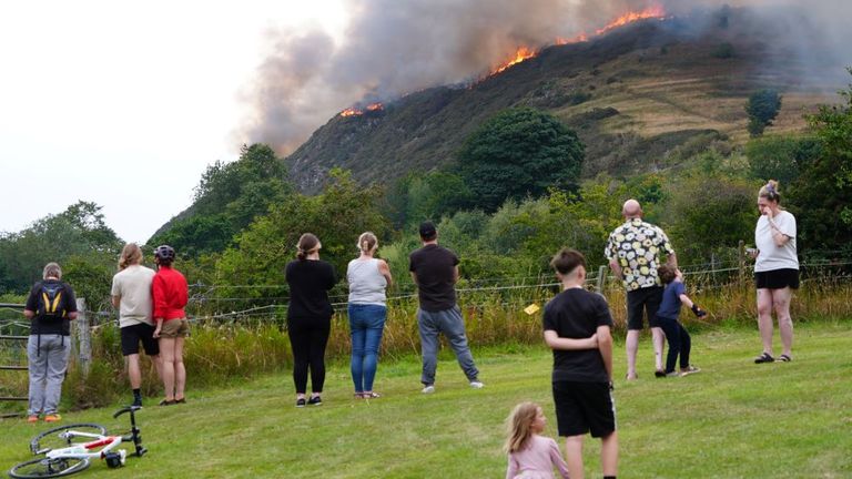 Members of the public watch the fire. Pic: PA 