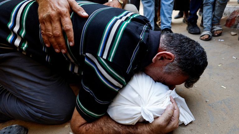 Mahmoud Abedrabo mourns over the body of his son Hamada in Gaza City on 24 August. Pic: Reuters