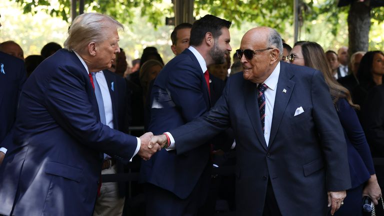 Donald Trump greets Rudy Giuliani while attending the 9/11 Memorial ceremony. Pic: AP/Yuki Iwamura