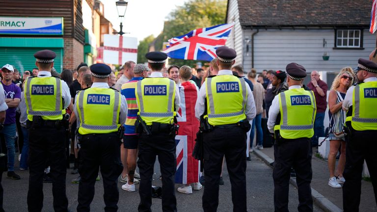 A protester draped in a Union Flag outside an asylum hotel in Orpington. Pic: PA