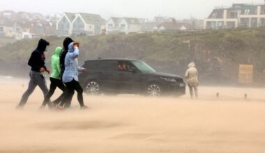 People run for cover as Storm Floris hits the north coast of Northern Ireland. Pic: Reuters
