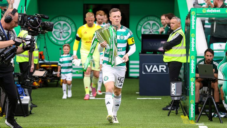 GLASGOW, SCOTLAND - AUGUST 03: Celtic's Callum McGregor enters the field carrying the Scottish Premiership trophy during a William Hill Premiership match between Celtic and St Mirren at Celtic Park, on August 03, 2025, in Glasgow, Scotland. (Photo by Craig Williamson / SNS Group)