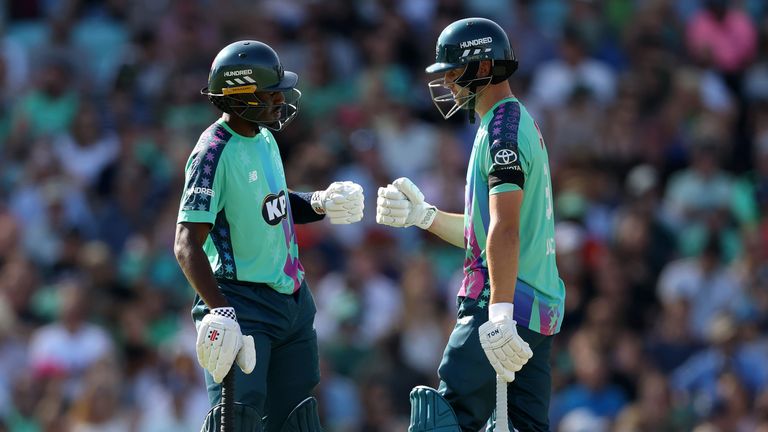 LONDON, ENGLAND - AUGUST 09: Tawanda Muyeye of Oval Invincibles is congratulated by team mate Will Jacks after reaching his half century dur