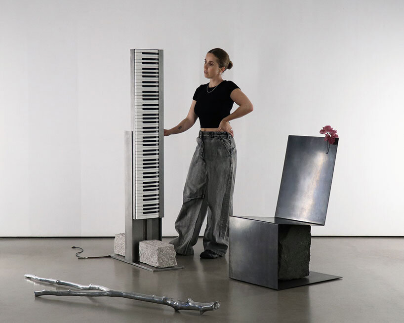 carved in steel and stone, sculptural electronic piano transforms from instrument to monolith