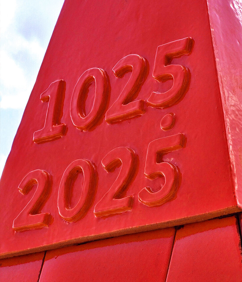 studio 5•5 rises 101st spire in caen as a glowing red monument to the city's millennium