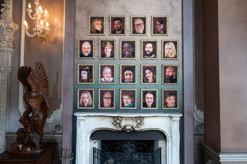 the celebrity traitors cast as seen in picture frames on a wall above the fireplace including alan carr cat burns celia imrie charlotte church clare balding david olusoga joe marler joe wilkinson jonathan ross kate garraway lucy beaumont mark bonnar nick mohammed niko omilana paloma faith ruth codd stephen fry tameka empson and tom daley
