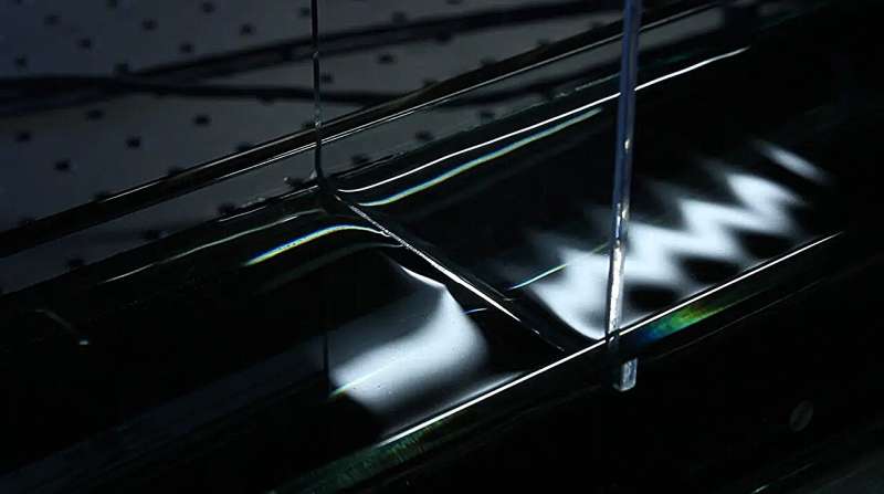 A wave travels through a tank in Likun Zhang's laboratory at the National Center for Physical Acoustics. Credit: University of Mississippi Tiny waves, big impact: Study finds new way to control fluid in space