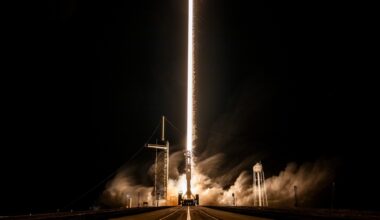 a white rocket lifts off above a plume of fire